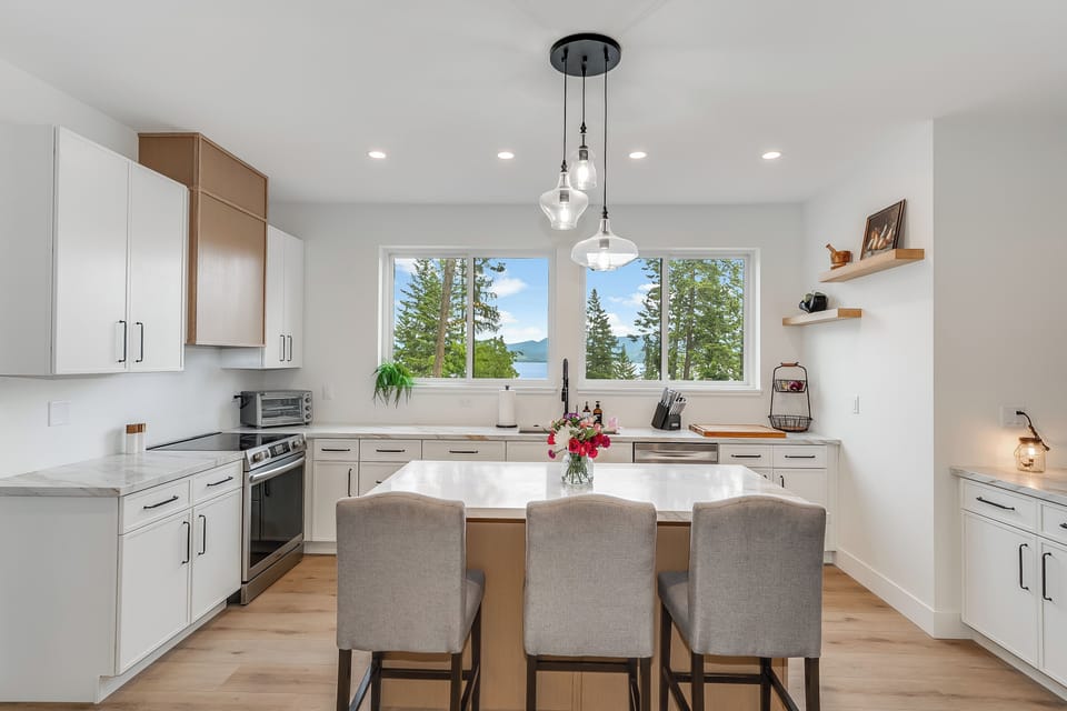 A bright kitchen with lake and mountain views where you'll love preparing meals together. Modern appliances meet natural beauty right from your countertop.