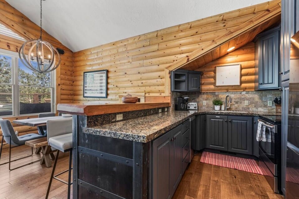 Mountain retreat kitchen equipped for home cooking, featuring full-size appliances and convenient access to the dining and living areas for easy gathering