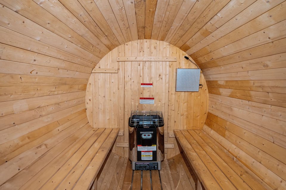 Traditional barrel sauna with spacious cedar interior.