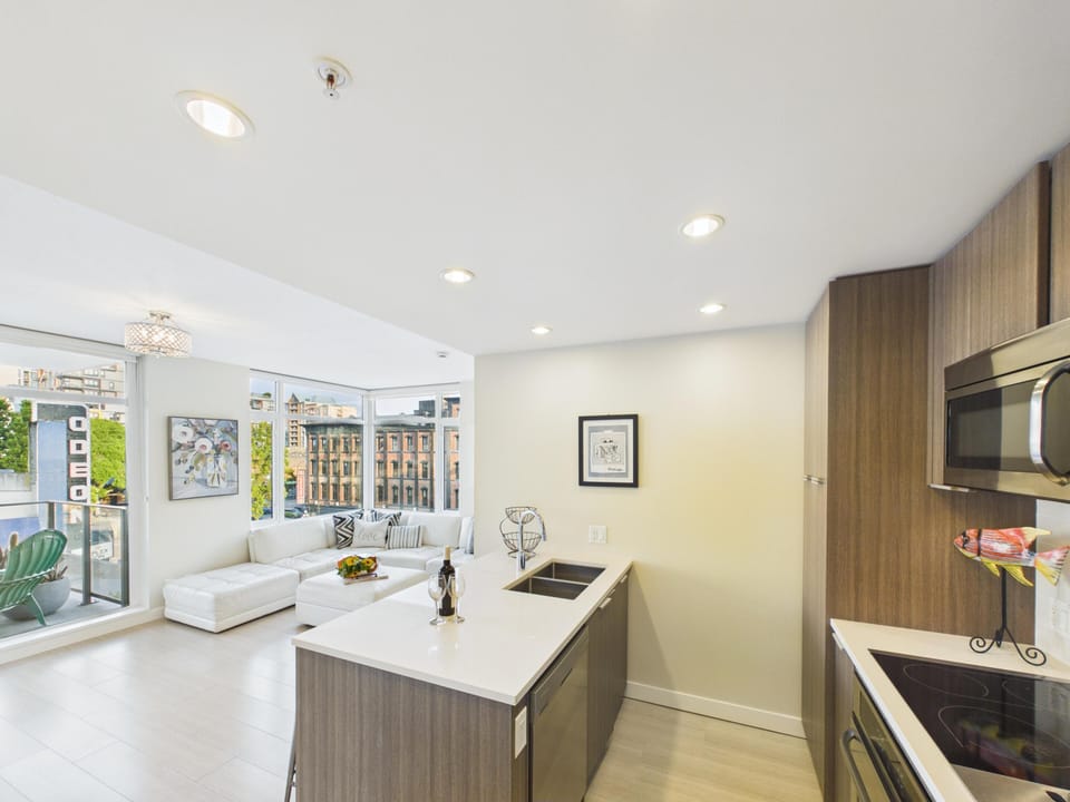 A sleek, open-concept kitchen layout designed with a spacious central island and breakfast bar seating.