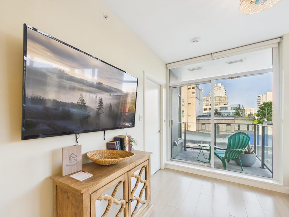An alternate view of the bright lounge showing the seamless transition to your private outdoor balcony.