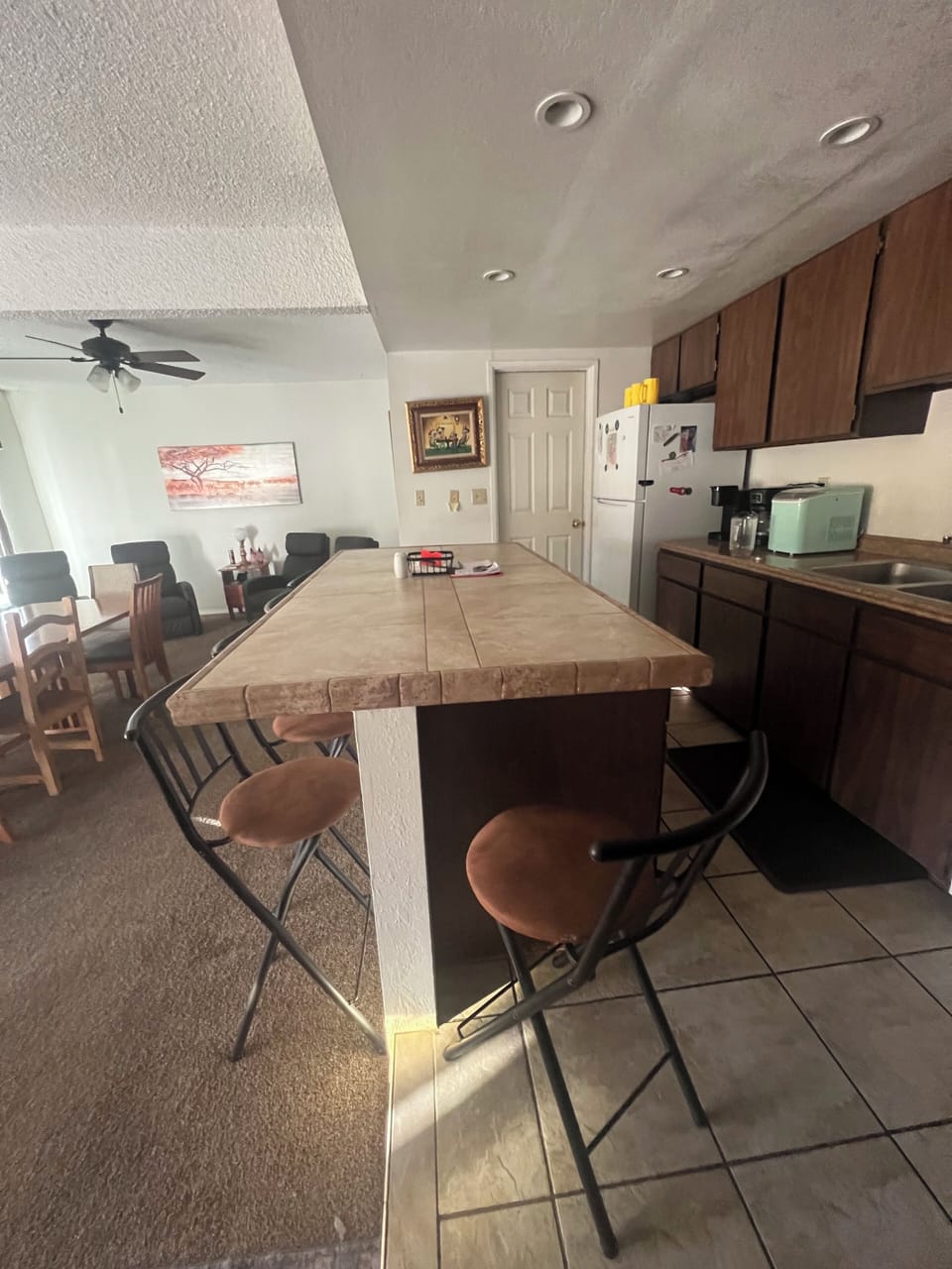 Island bar stools for eating and conversation with open floor plan. 