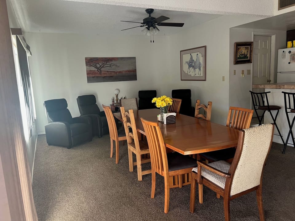Large dining table and sitting area open to the kitchen. 