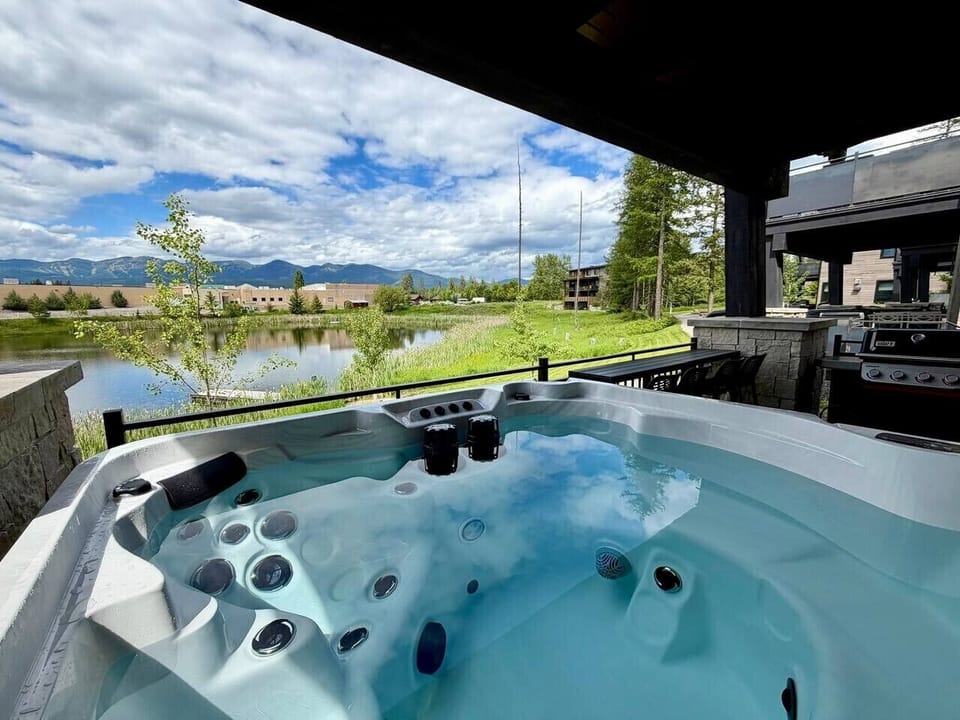 Snowghost Social offers a covered private hot tub with lake and mountain views, perfect for soaking in comfort year-round.