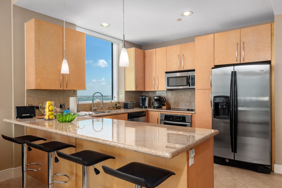 Cook favorite meals in a bright kitchen with water views and bar seating.