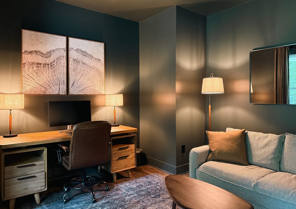 Cozy modern lounge with dedicated workspace and warm designer touches