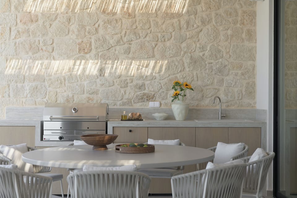 The gas BBQ, sink, and fridge create an effortless outdoor kitchen setting for l