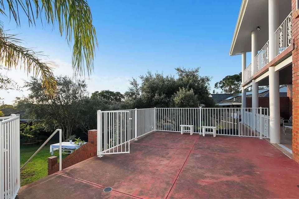 Courtyard with stairs leading down to the backyard. Ground floor