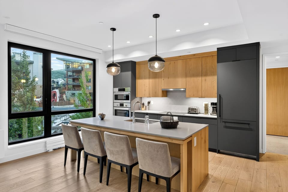 Modern kitchen setup featuring ample countertop space and a massive island breakfast bar.