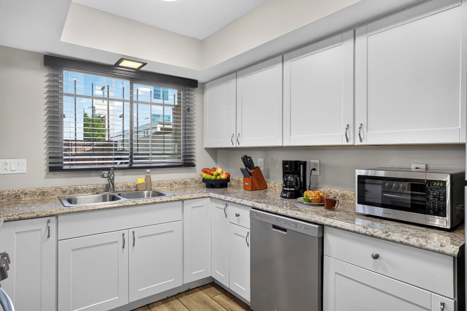 Bright kitchen with granite counters, stainless steel appliances, and plenty of prep space.