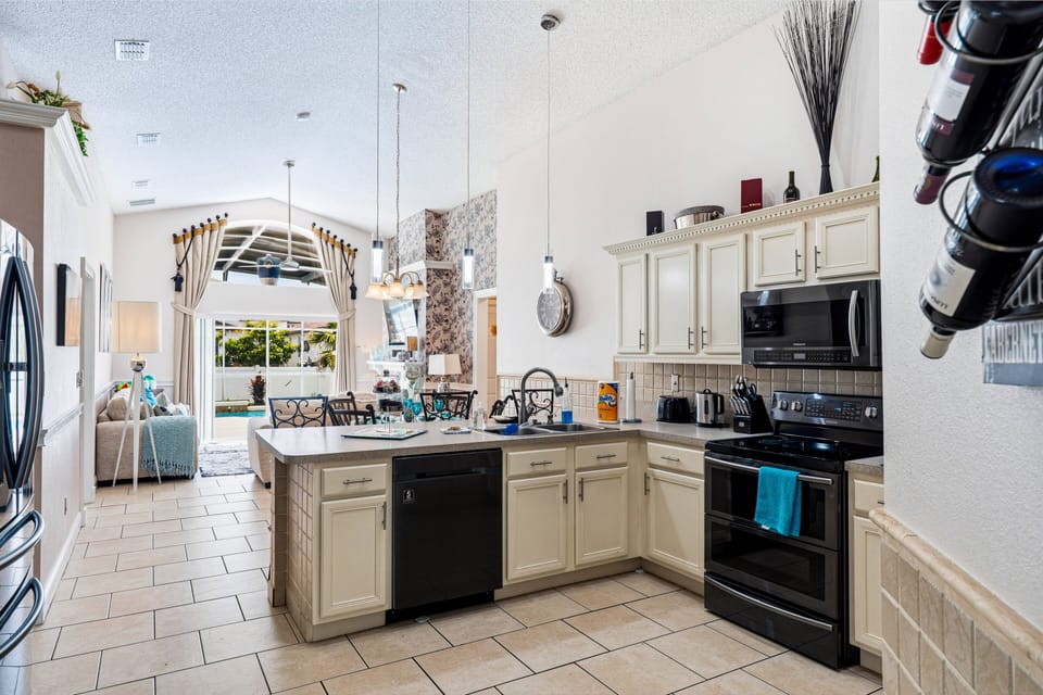 Modern, fully equipped kitchen with breakfast bar, quality appliances, and everything you need to prepare meals, snacks, and drinks throughout your stay.