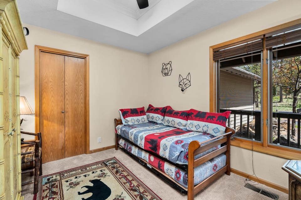 Cozy daybed ready for restful moments, with rustic animal-themed decor and easy access to your private outdoor space.
