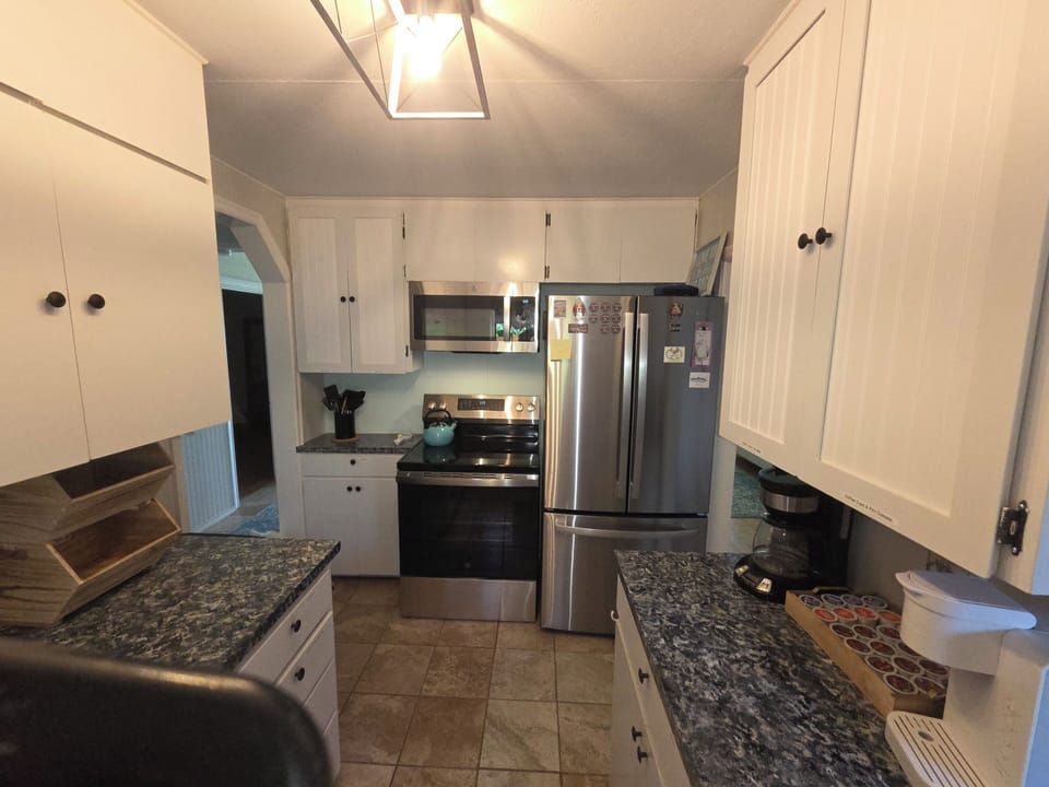 Cook with Ease – A stylish kitchen featuring updated stainless steel appliances.