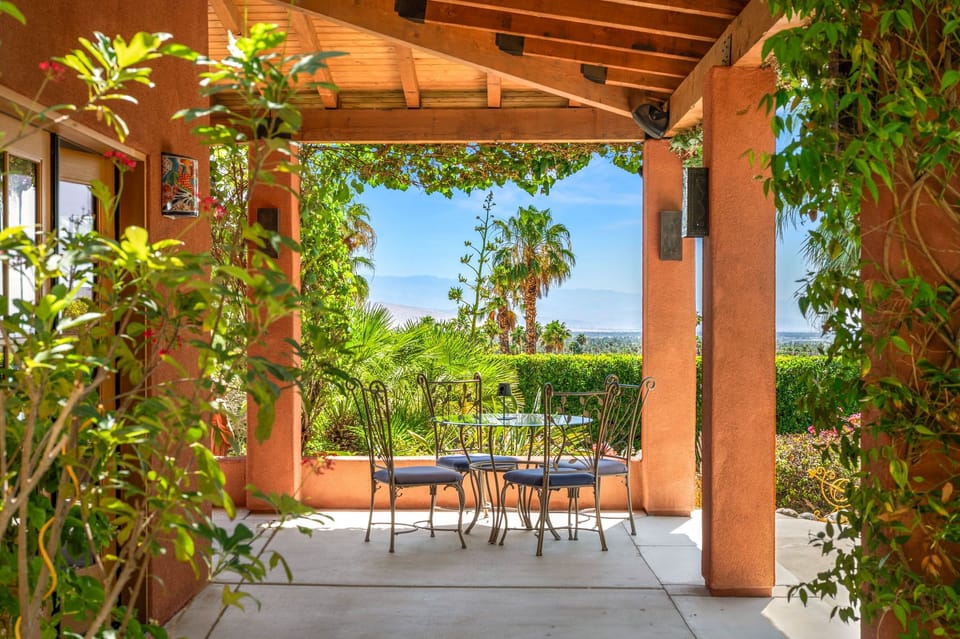 Step into your private patio, framed by lush greenery and warm terracotta tones. Sip morning coffee at your outdoor table as tropical palms sway and pool views stretch beyond.