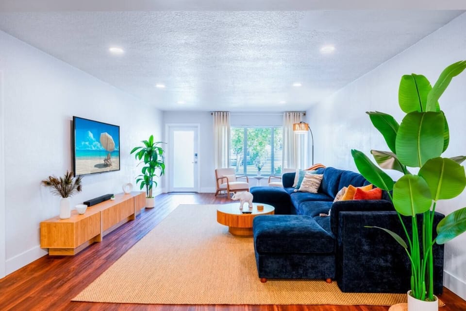 Japandi-Boho living room, every piece brand new. Smart TV and sound system, room-darkening shades for afternoon naps, and a separate space from the dining area so late talkers don't wake early sleepers.