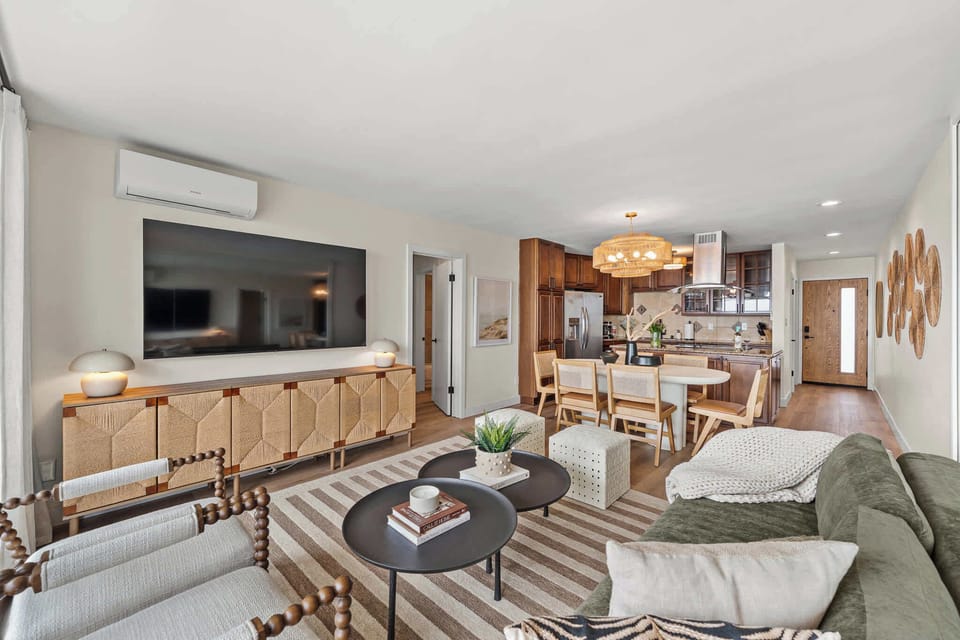 Living Room with sweeping ocean views, a queen size futon, and a large smart TV.