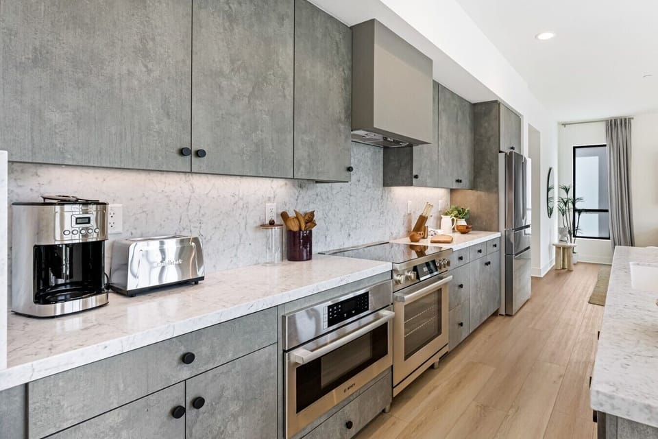 Sleek marble-topped kitchen with full-size appliances, ready for everything from your morning coffee to a home-cooked dinner.