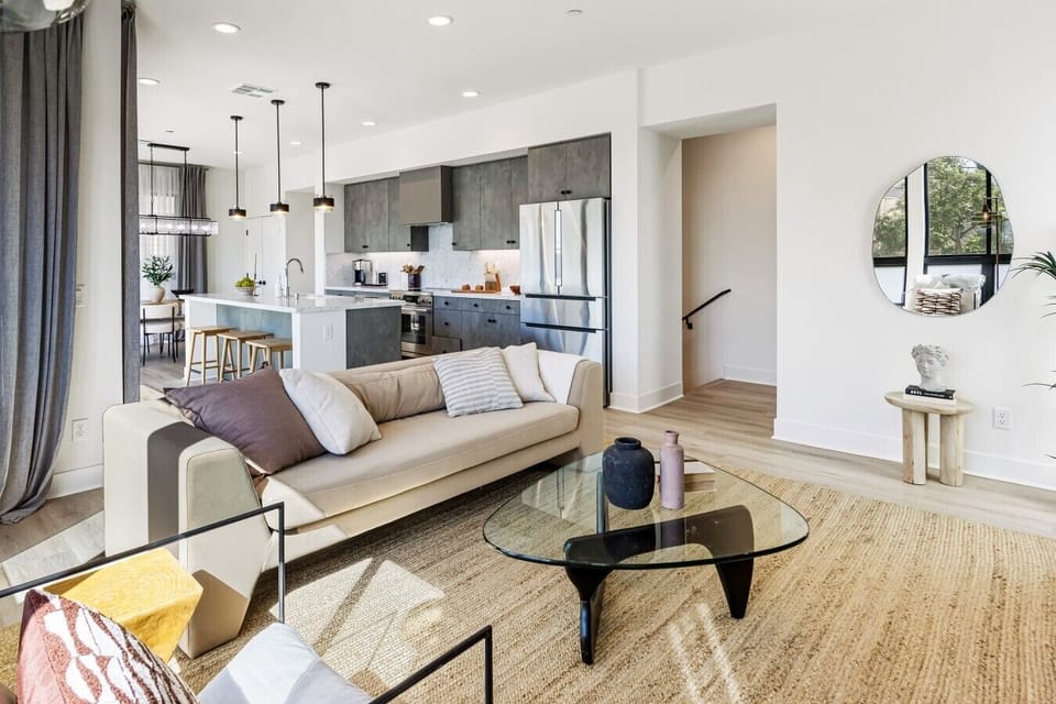 Bright, open-concept living area that flows straight into the kitchen, ideal for stretching out or catching up on work.