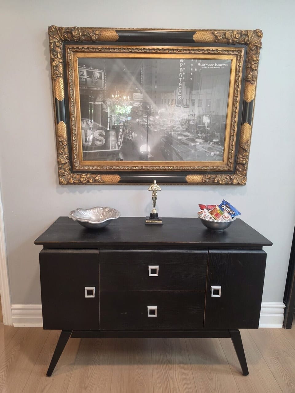 A charming entryway featuring a vintage Hollywood Boulevard print and a touch of old-school glamour to set the tone for your stay.