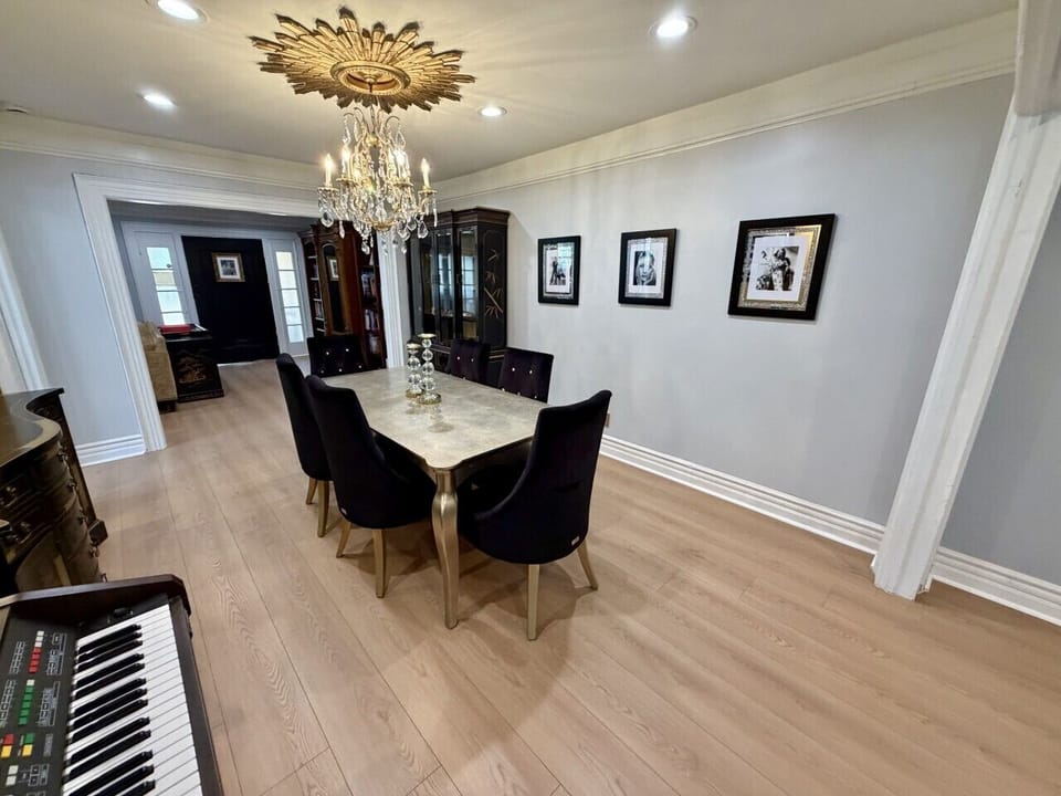 Gather around the elegant dining area, where a stunning chandelier sets the stage for memorable meals and conversations. Flowing seamlessly between the living room and the dramatic chef`s kitchen, this inviting space is perfect for everything from casual 