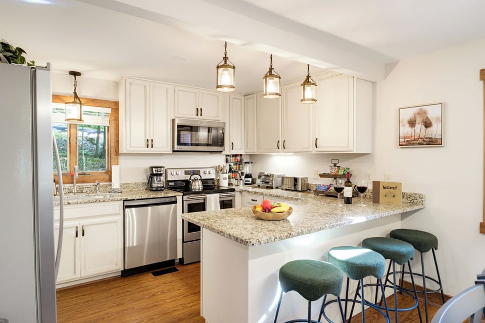 Bright modern kitchen with granite island seating for four