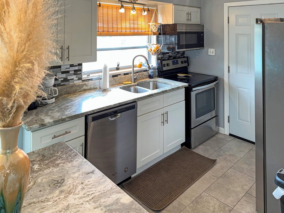 Bright modern kitchen with stainless appliances and stylish finishes