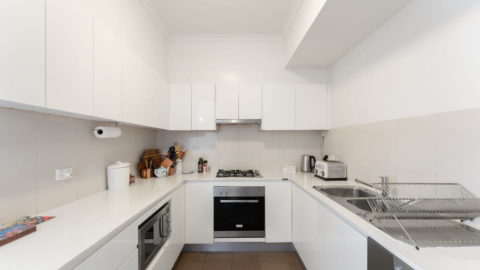 Cook with ease in the fully equipped kitchen featuring modern appliances and generous bench space.