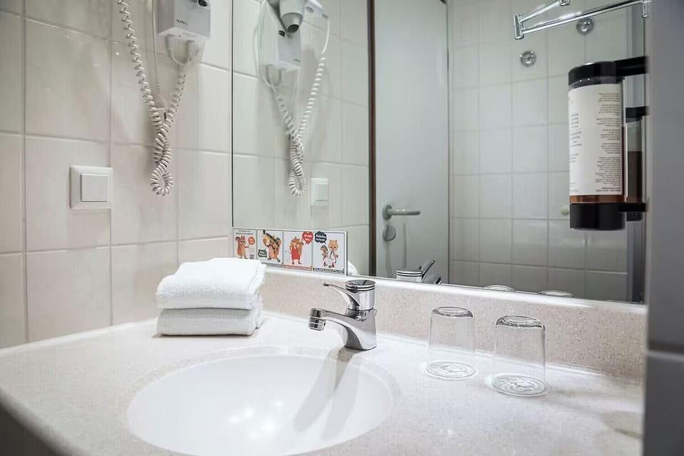 Refresh at the spotless vanity with plush towels provided.