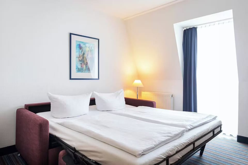 Lounge comfortably on the sofa bed beside soft, warm lighting.