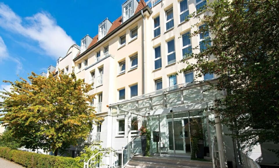 Step up to the welcoming entrance canopy and leafy frontage.