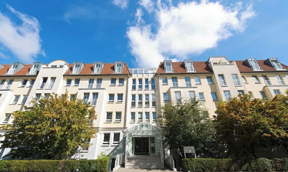 Arrive to a sunlit façade that promises an easy check-in.