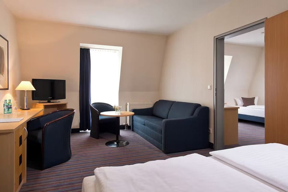 Spread out in a suite-like layout with seating and workspace.