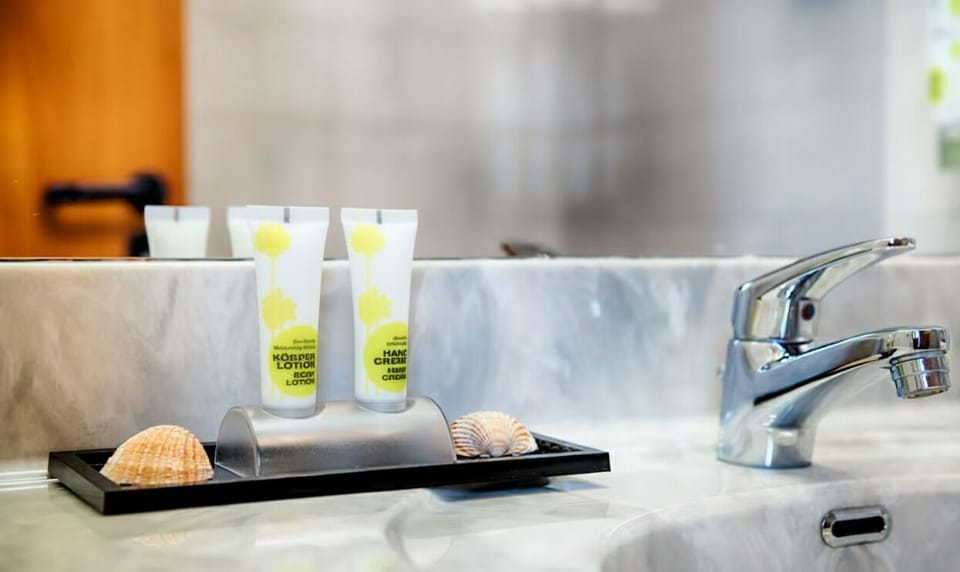 Refresh with thoughtful toiletries on a clean, bright vanity.