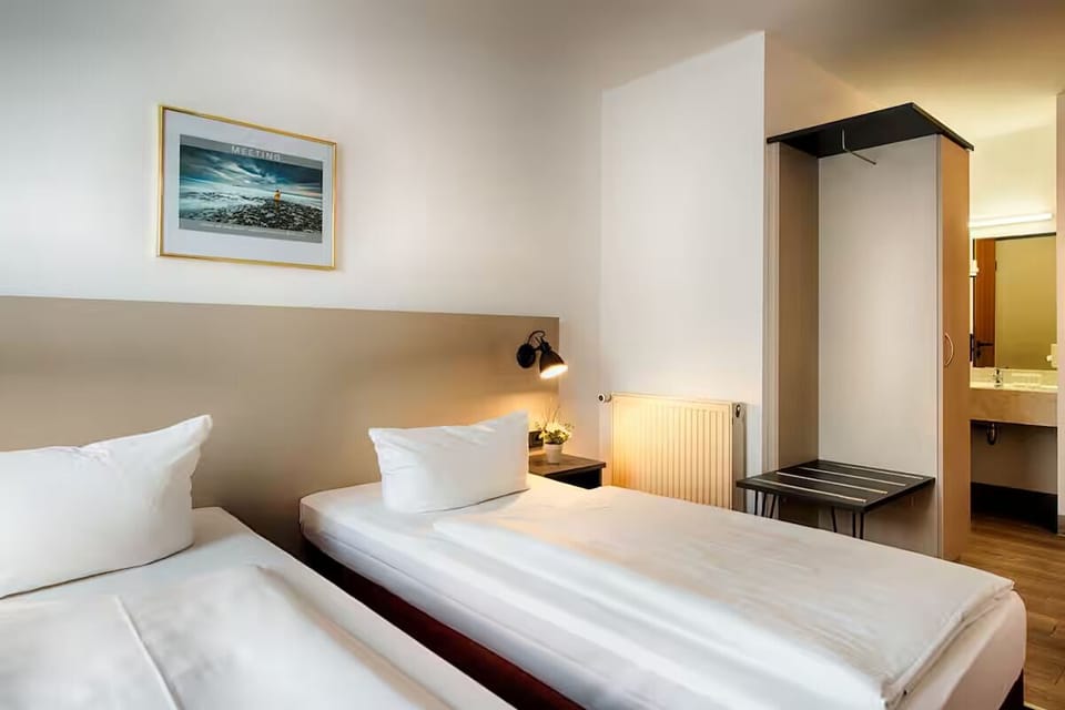 Rest easy with separate beds and warm bedside lighting.
