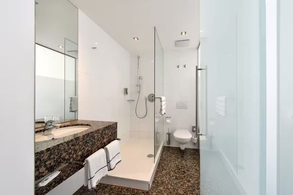 Rinse off in a glass-walled shower with spa-like simplicity.