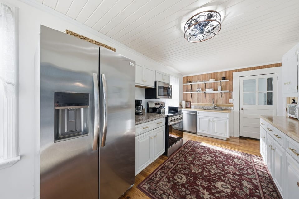Fully equipped kitchen with stainless steel appliances.