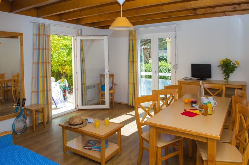 The bright open-plan living and dining area, with direct access to the private terrace.