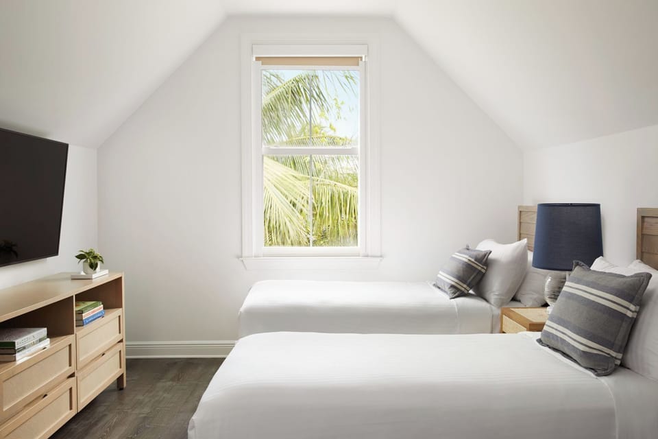 Recharge in a cozy twin room with calming palm views.