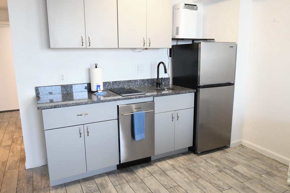 Step into your fully equipped kitchenette with modern stainless steel appliances, granite counters, and everything you need to prepare your favorite meals during your stay.
