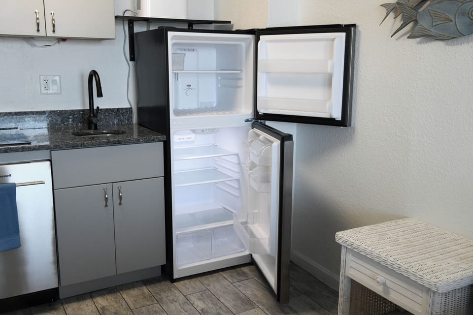 A full-size refrigerator with freezer ensures you have space to stock your favorite snacks and keep drinks cold throughout your stay.