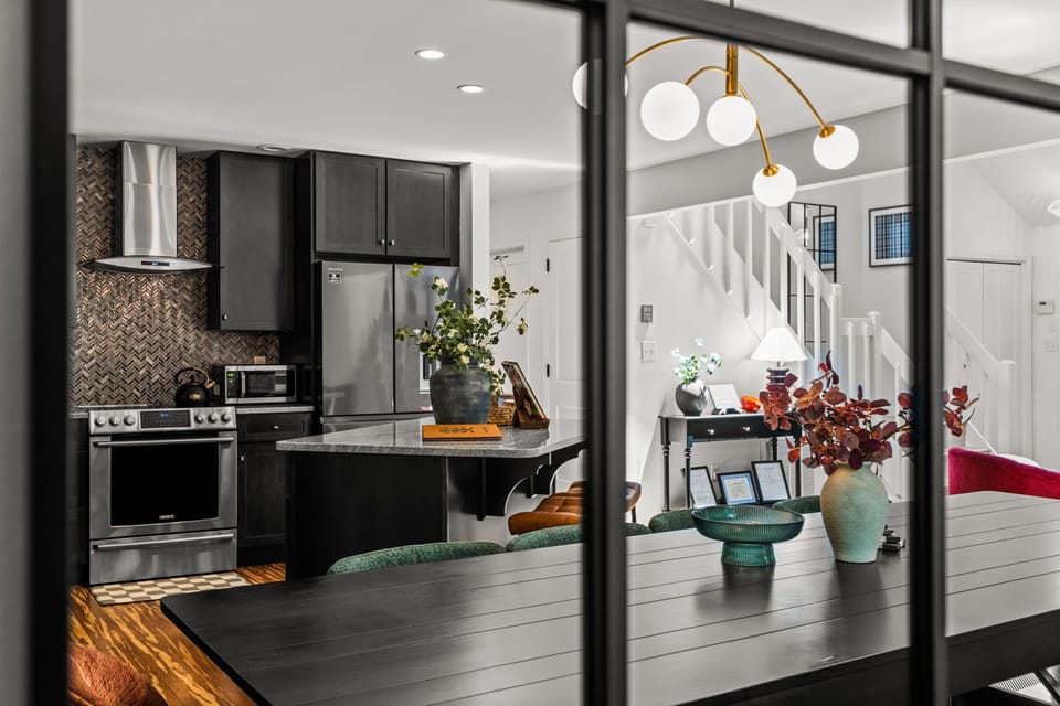 Modern open-concept kitchen with island, designer lighting, and chic finishes