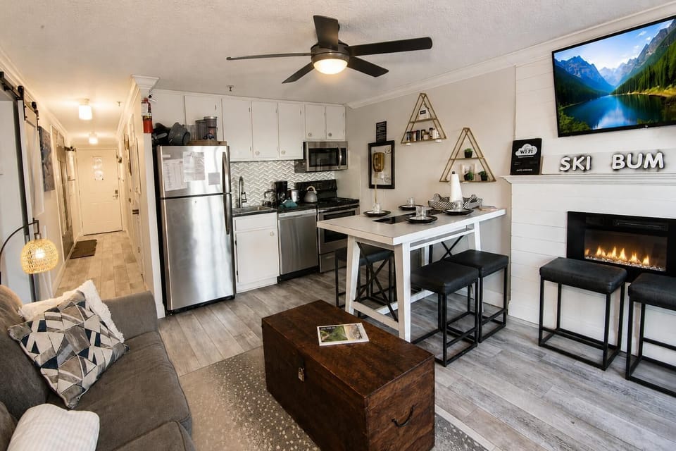 Unwind in the inviting living room with a cozy gas fireplace and TV for the perfect evening indoors.