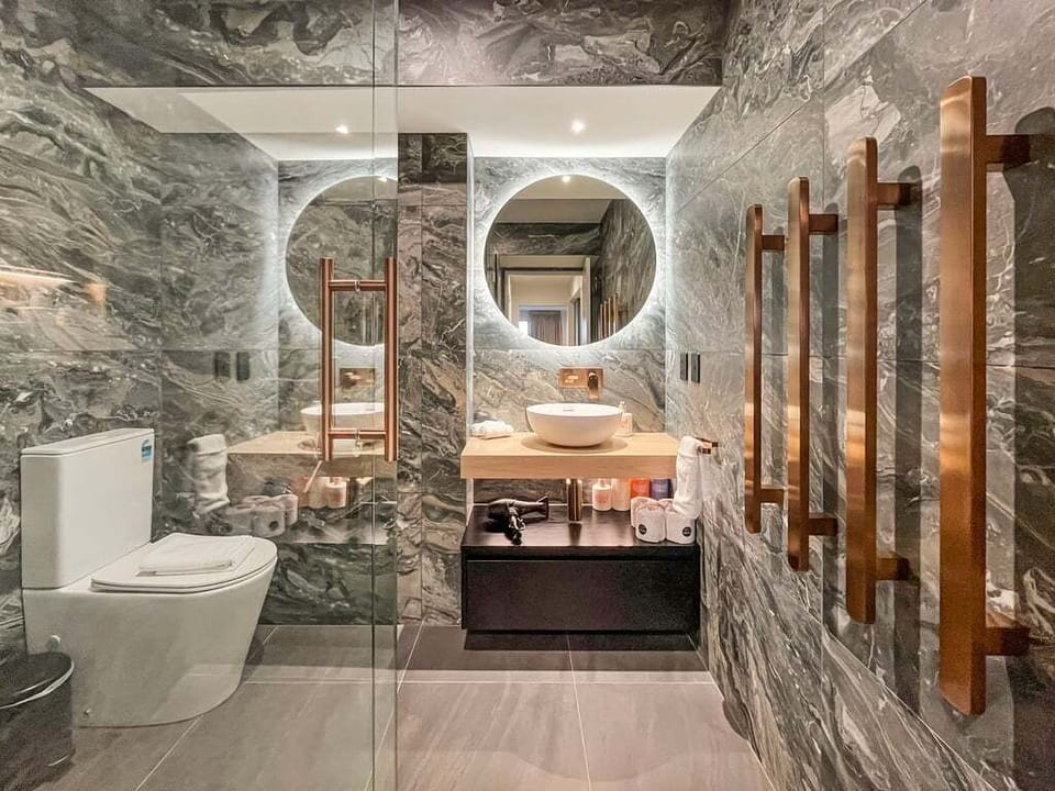 Indulge in the luxurious marble bathroom with premium fixtures and a spacious walk-in shower.