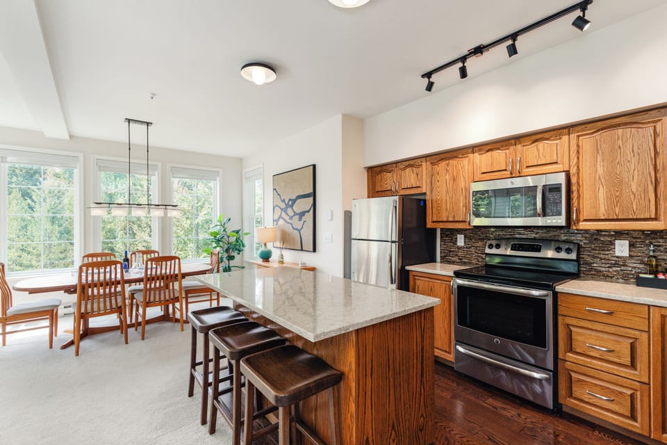 Kitchen - Island with bar seating, fully equipped, light-filled — everything you need for a great family dinner