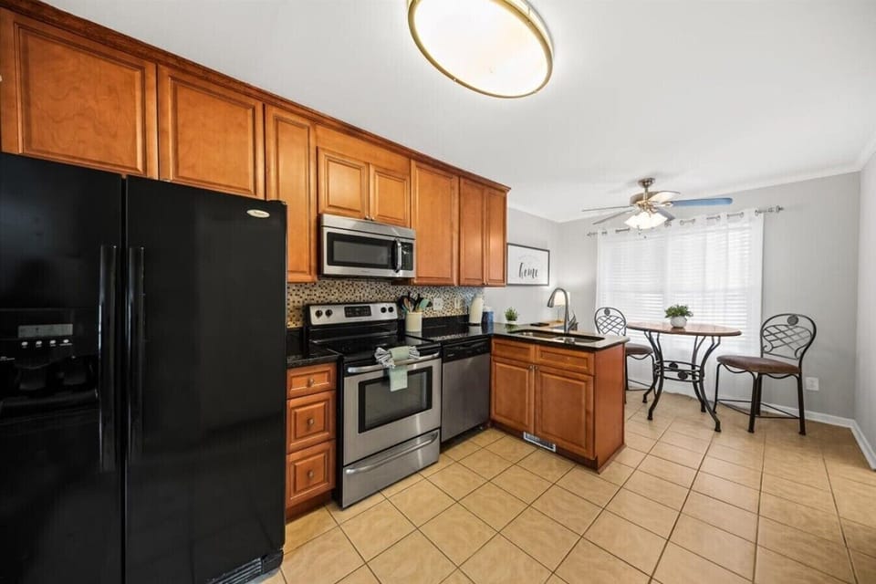 Cook actual meals here — full stove, microwave, and enough counter space to move around. The kitchen is stocked for a month, not just a weekend.