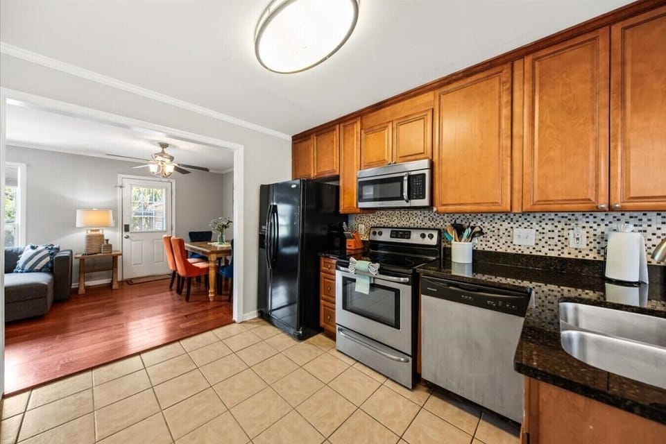 The kitchen opens directly into the living and dining area — cook and stay in the conversation at the same time.