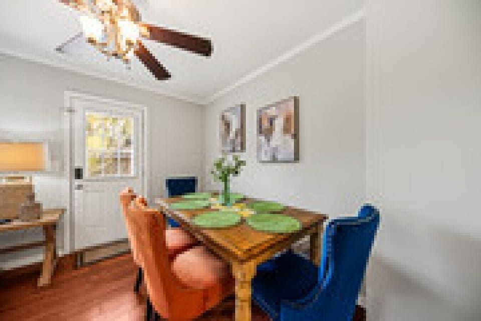 Four chairs around the dining table, and the back door right behind it — short walk between setting the table and grabbing something off the grill.