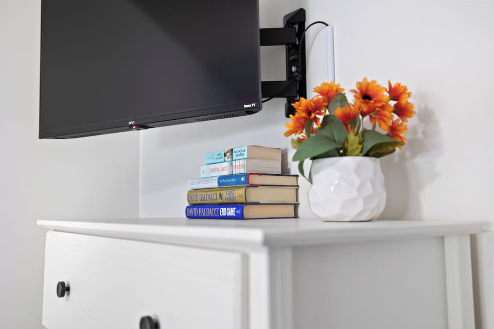 Bedroom 2 - TV and books on dresser. 