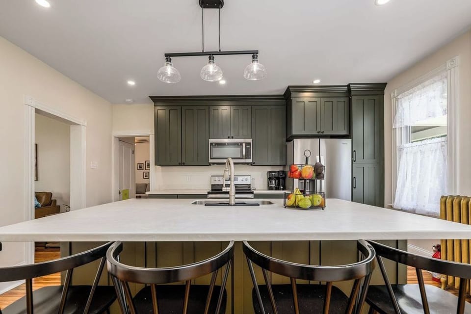 Fully equipped kitchen with service for 12. Views of front and back living rooms