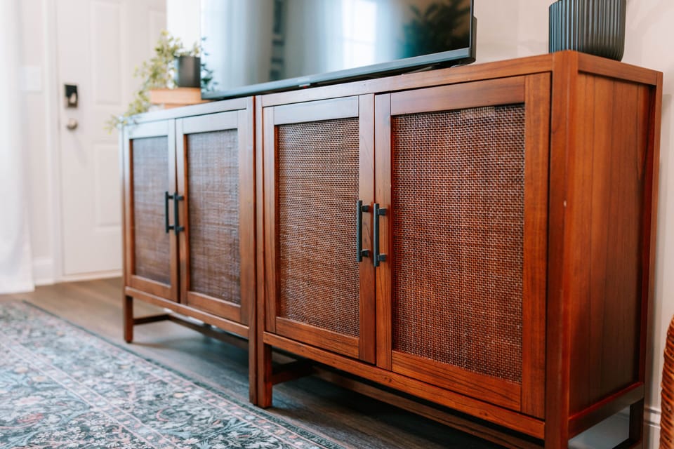 Relax in the living room with a Smart TV and warm wood console.